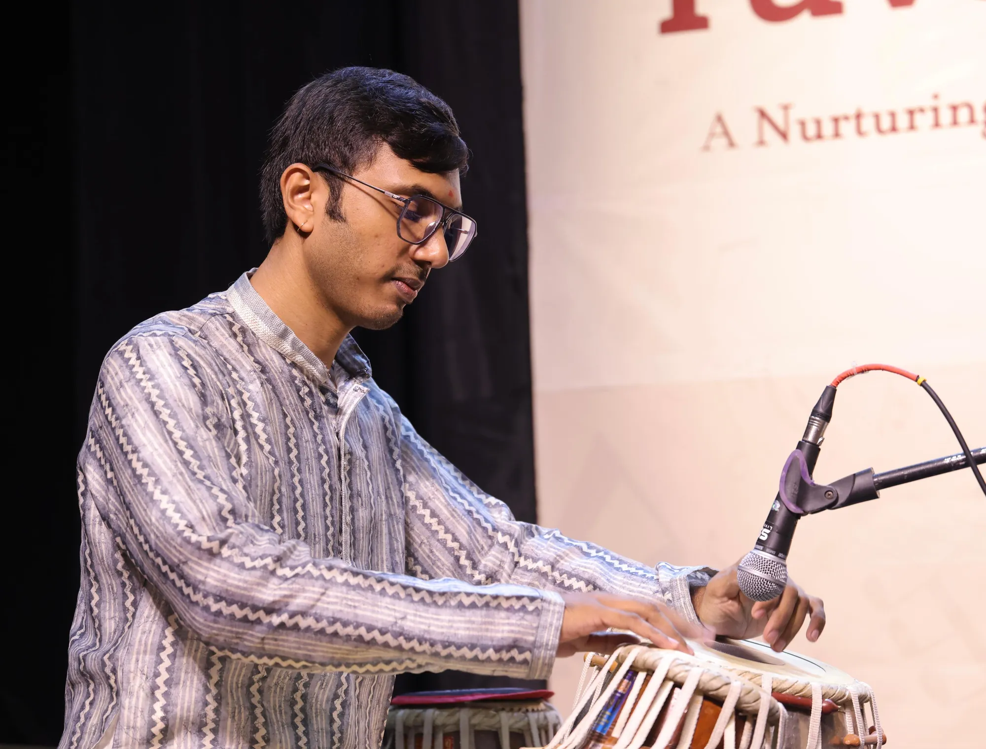Kaushik Bhat accompanying a vocalist on tabla at a concert in Bangalore