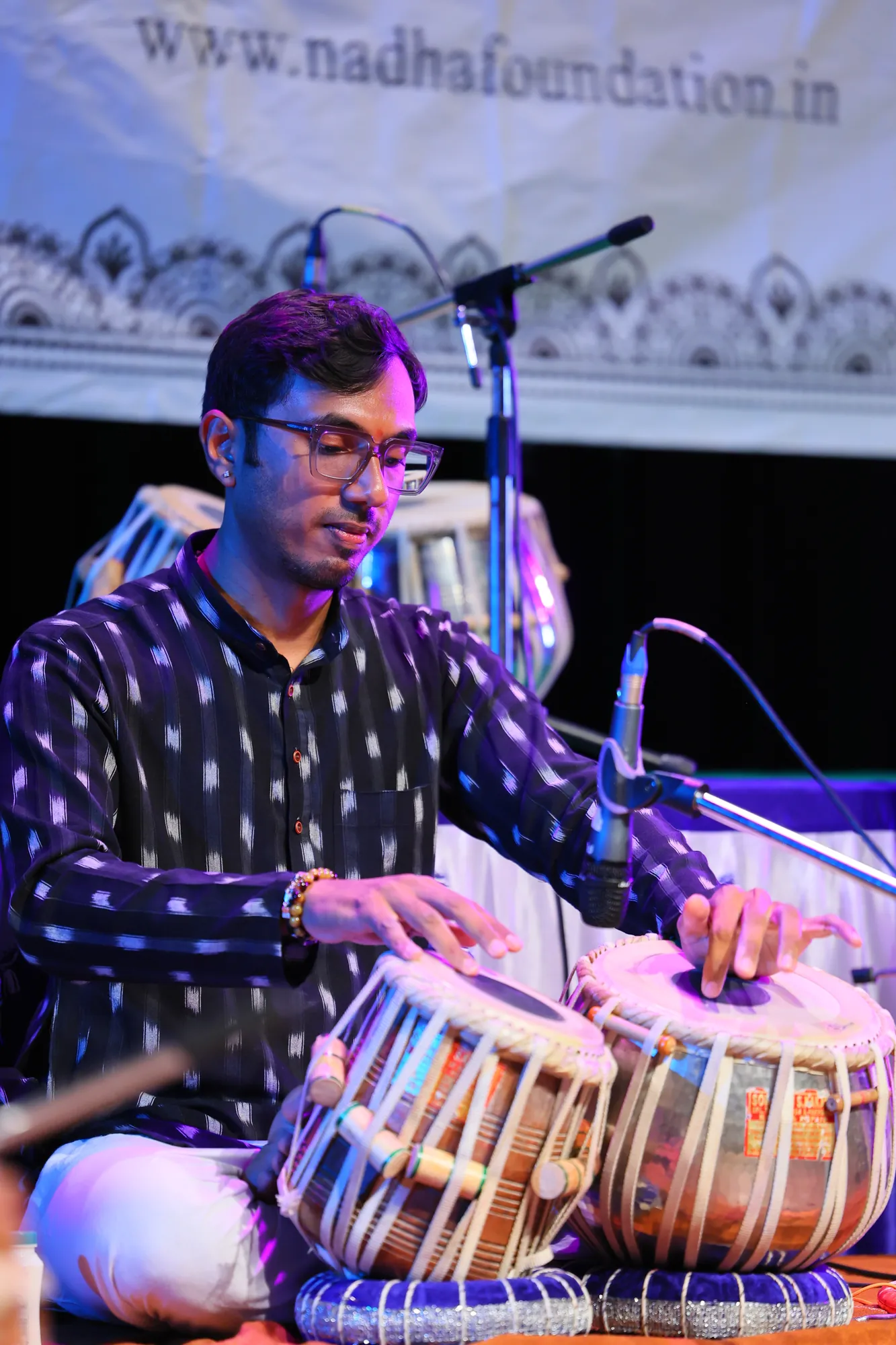 Tabla artist Kaushik Bhat performing on stage at a concert in Bangalore