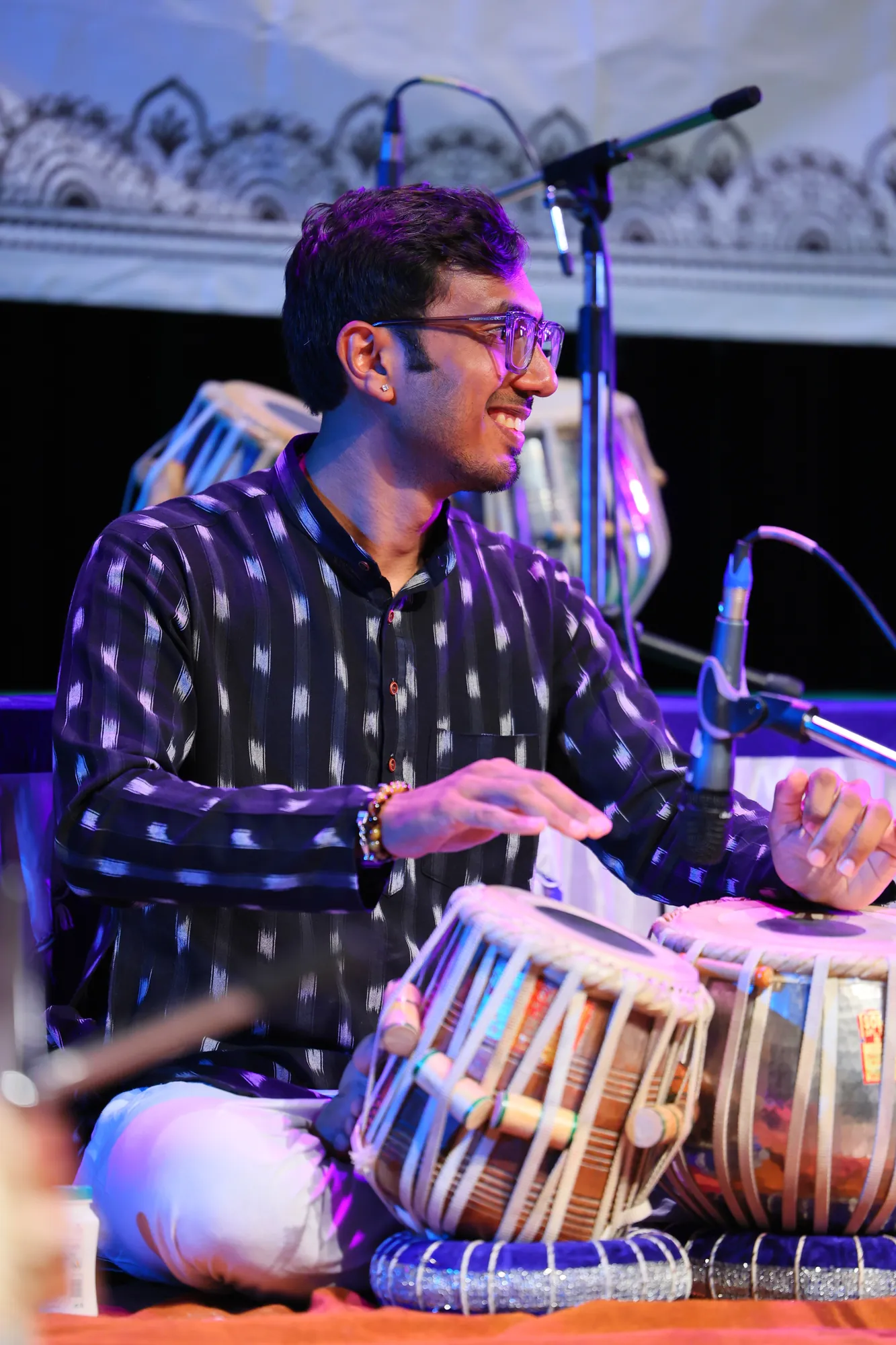 Close-up of Kaushik Bhat's hands on the tabla during a classical concert